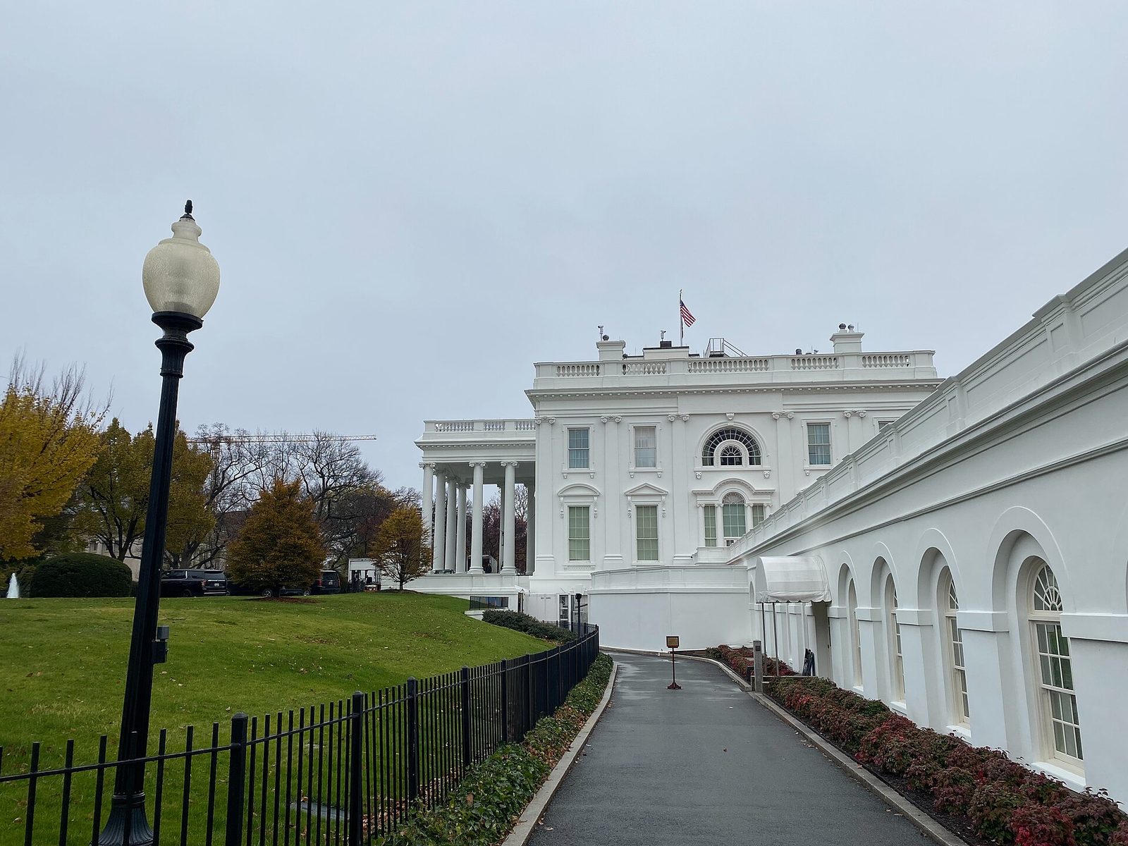White House and West Wing colonnade under overcast sky with walkway