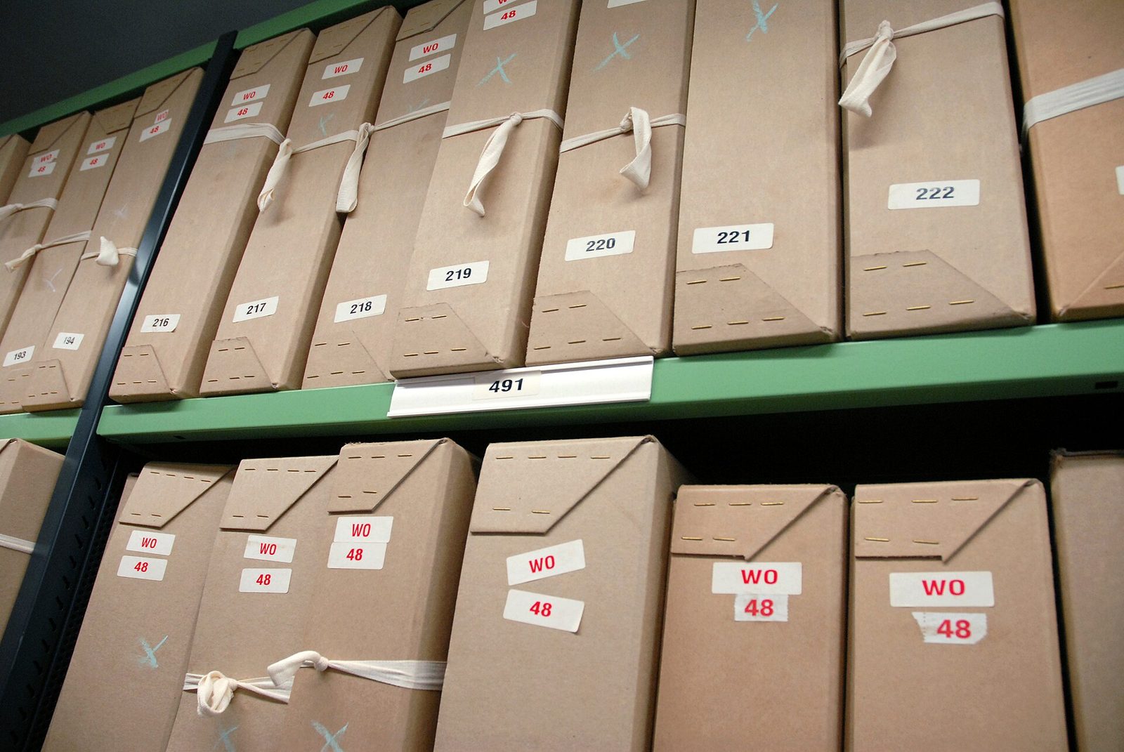 Boxes of documents on archive shelving at the UK National Archives