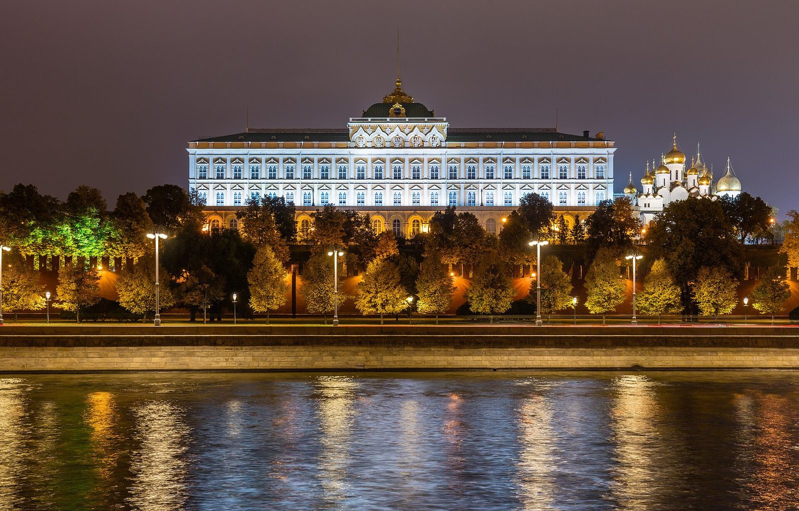 Grand Kremlin Palace lit at night above a river