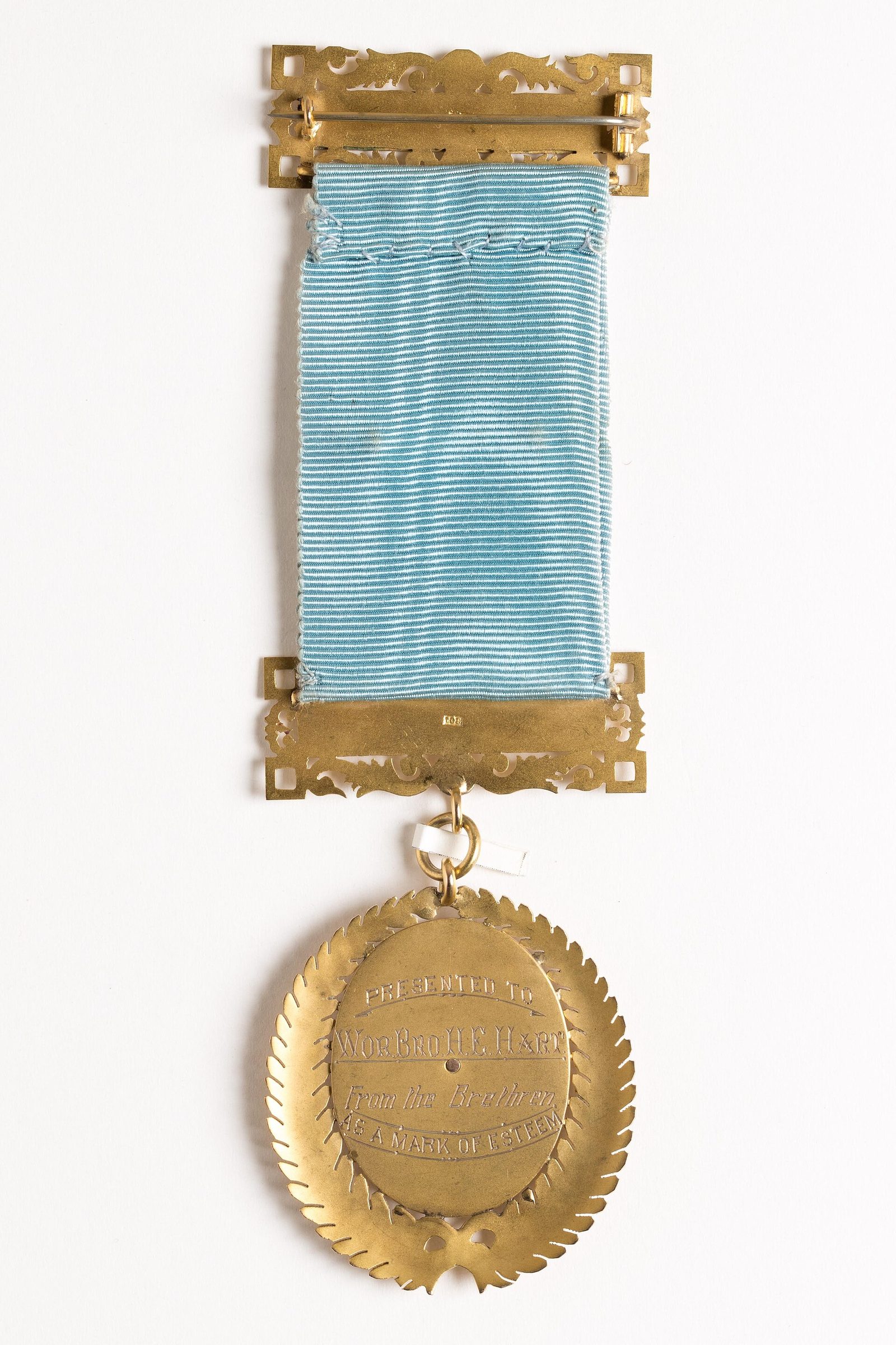 A medal hanging from a light-blue ribbon